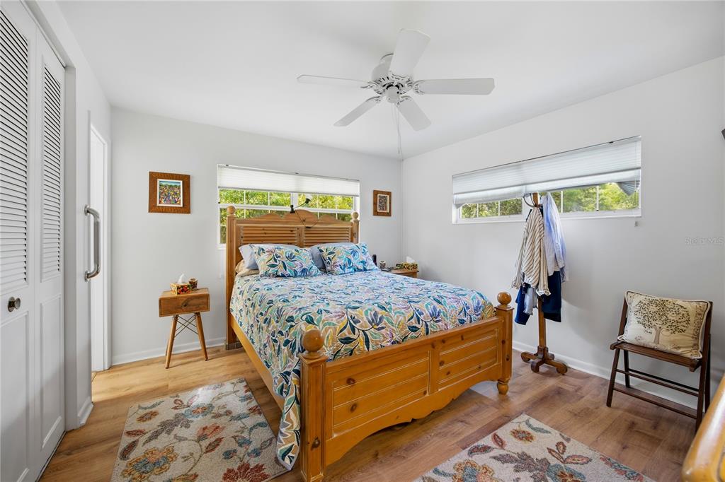 4123 Northwest 18th Place Gainesville, FL 32605 - Photo 20 of 36 a bedroom with a bed and wooden floor