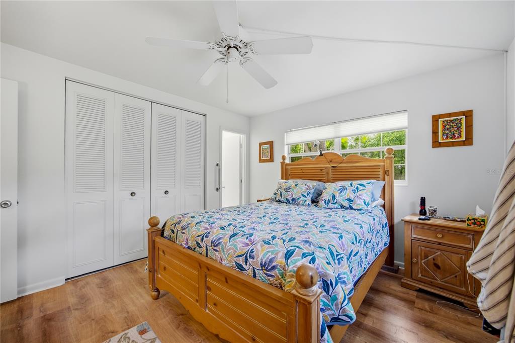 4123 Northwest 18th Place Gainesville, FL 32605 - Photo 21 of 36 a bedroom with a bed and wooden floor