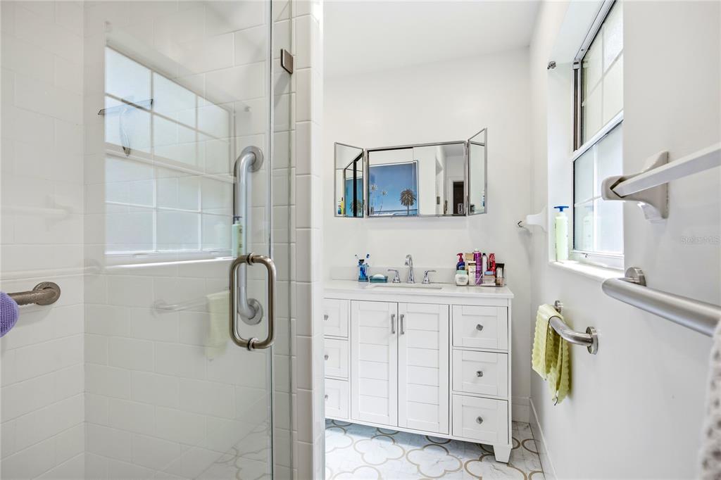 4123 Northwest 18th Place Gainesville, FL 32605 - Photo 22 of 36 a bathroom with a granite countertop sink a vanity and a mirror