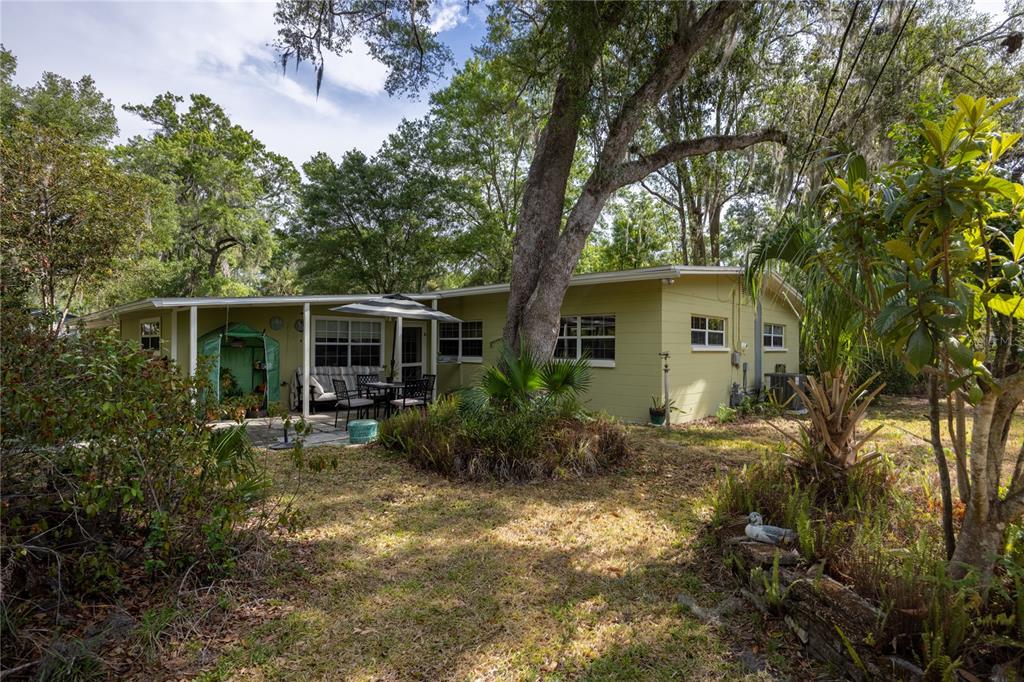 4123 Northwest 18th Place Gainesville, FL 32605 - Photo 25 of 36 a view of backyard with outdoor seating and green space