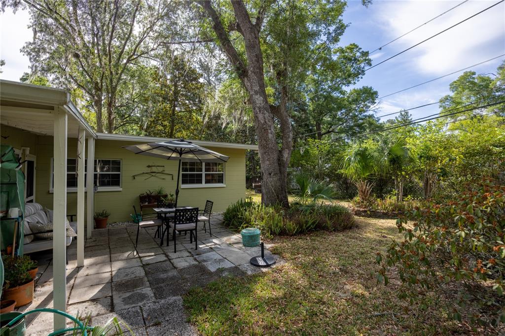 4123 Northwest 18th Place Gainesville, FL 32605 - Photo 31 of 36 a view of a house with backyard sitting area and garden
