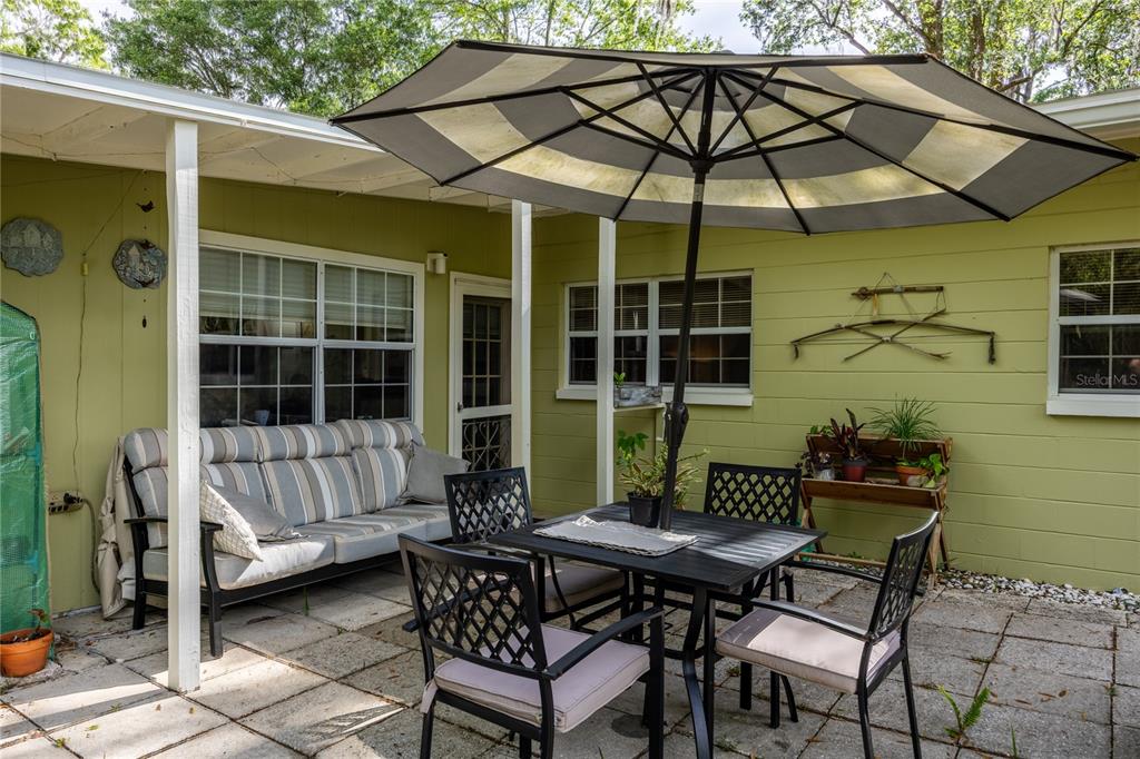 4123 Northwest 18th Place Gainesville, FL 32605 - Photo 33 of 36 a backyard of a house with table and chairs