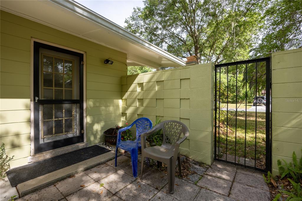 4123 Northwest 18th Place Gainesville, FL 32605 - Photo 34 of 36 a view of a chair and table in backyard of the house