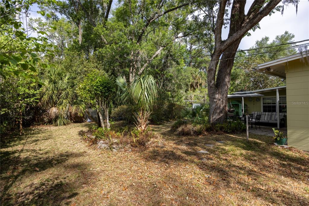 4123 Northwest 18th Place Gainesville, FL 32605 - Photo 35 of 36 a backyard of a house with table and chairs