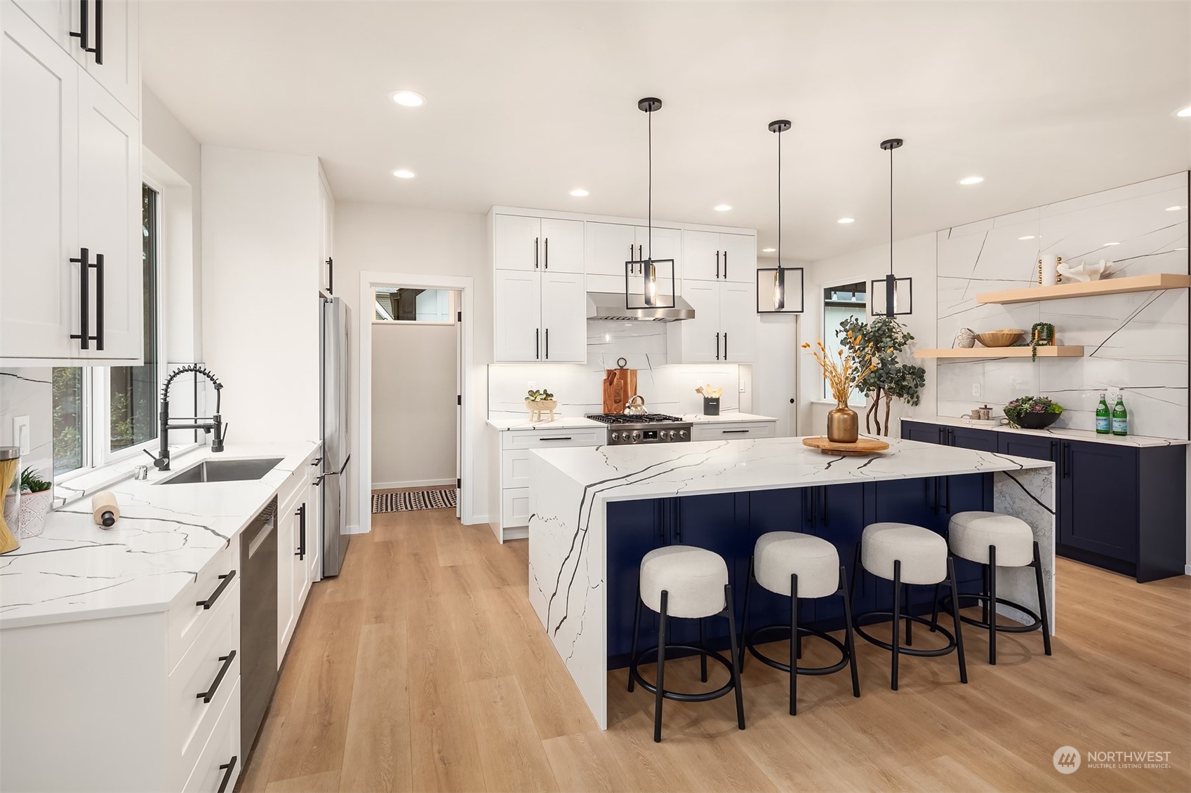 3234 Northeast 88th Street Seattle, WA 98115 - Photo 8 of 23 a dining room with stainless steel appliances kitchen island granite countertop furniture wooden floor and a rug