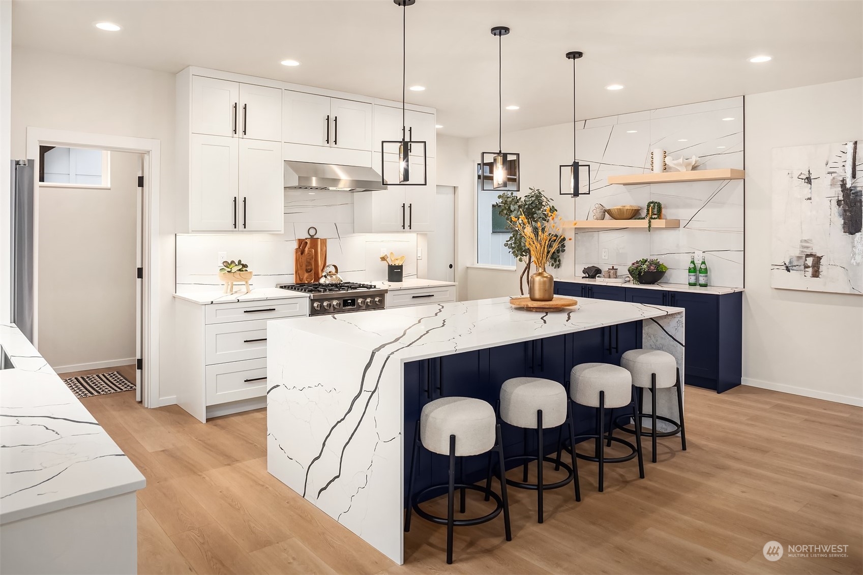 3234 Northeast 88th Street Seattle, WA 98115 - Photo 9 of 23 a kitchen with stainless steel appliances granite countertop a dining table chairs stove refrigerator and cabinets
