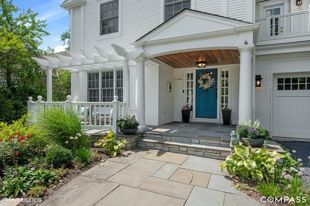a view of a house with potted plants
