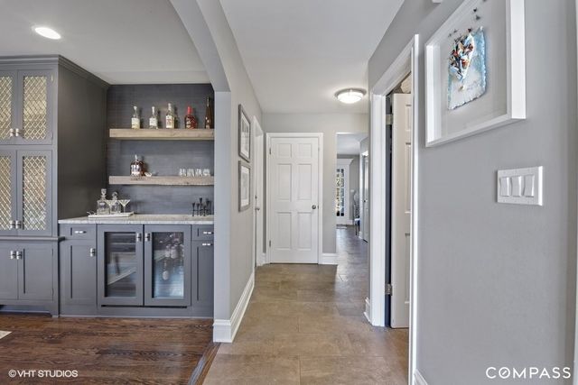 a view of a hallway to rooms and kitchen