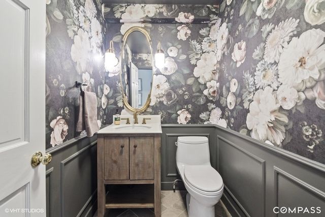 a bathroom with a toilet sink and mirror