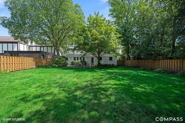 a front view of a house with a yard and table and garden