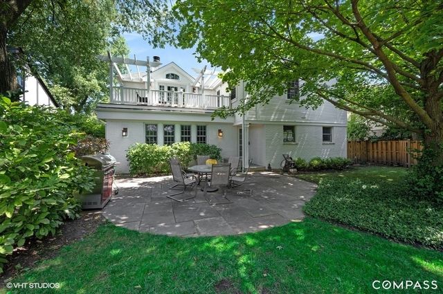 a view of a patio with a table chairs and a garden