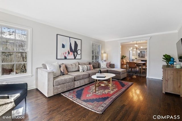 a living room with furniture a rug and a window