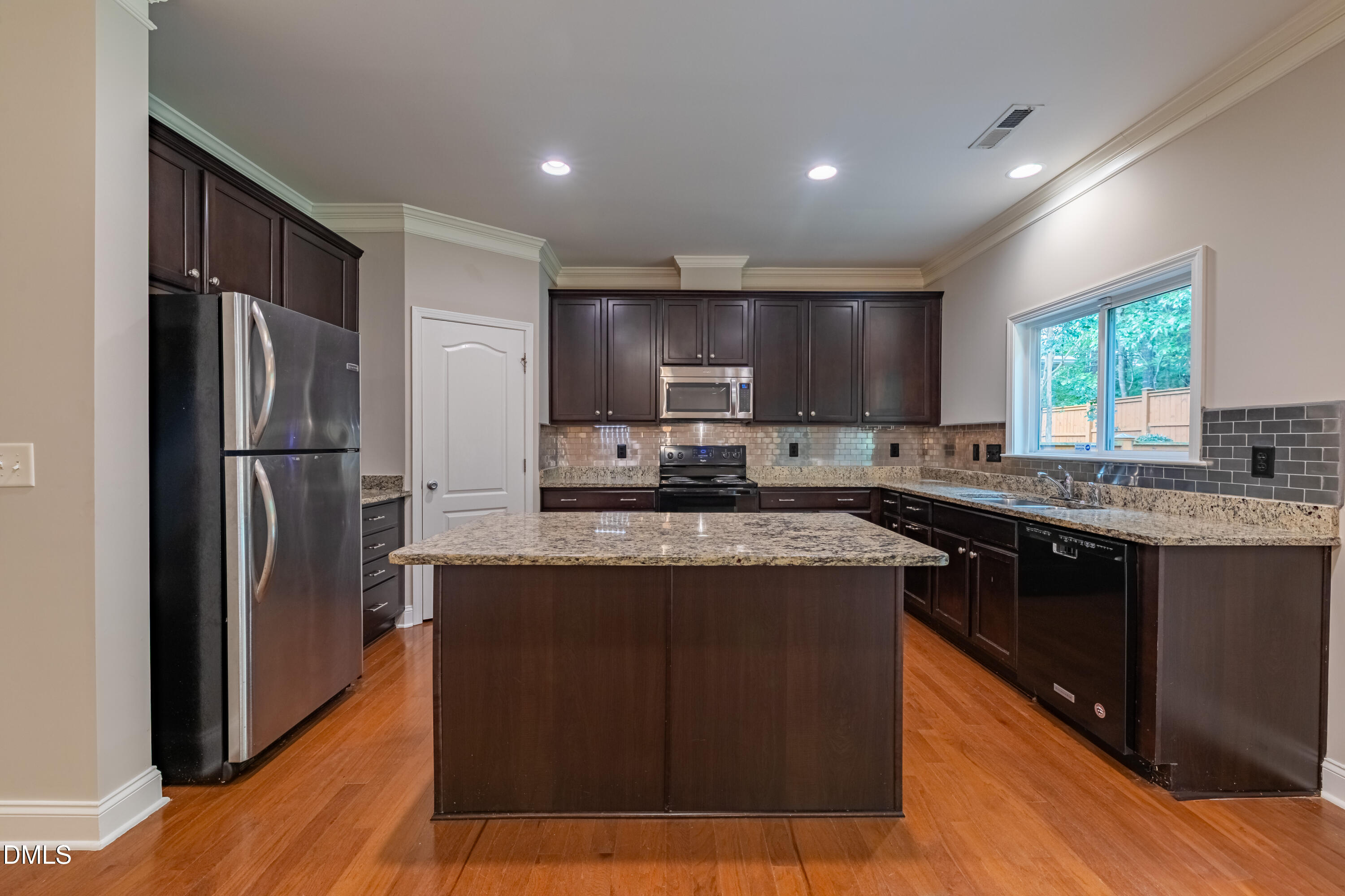 33 Juliette Drive Durham, NC 27713 - Photo 14 of 39 a kitchen with stainless steel appliances granite countertop a refrigerator a sink a stove a microwave and wooden cabinets