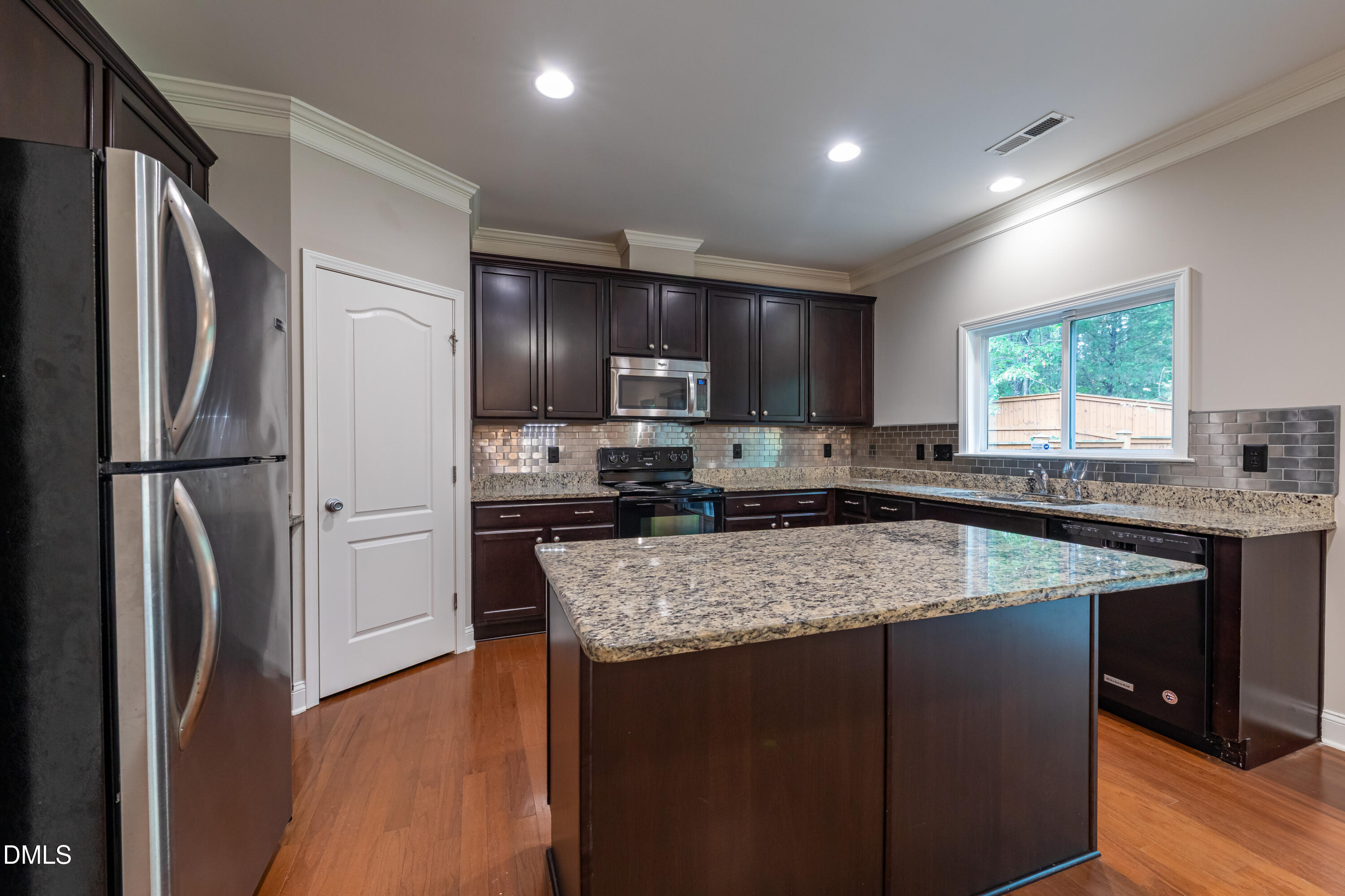 33 Juliette Drive Durham, NC 27713 - Photo 16 of 39 a kitchen with stainless steel appliances granite countertop a refrigerator a sink a stove a microwave and wooden cabinets