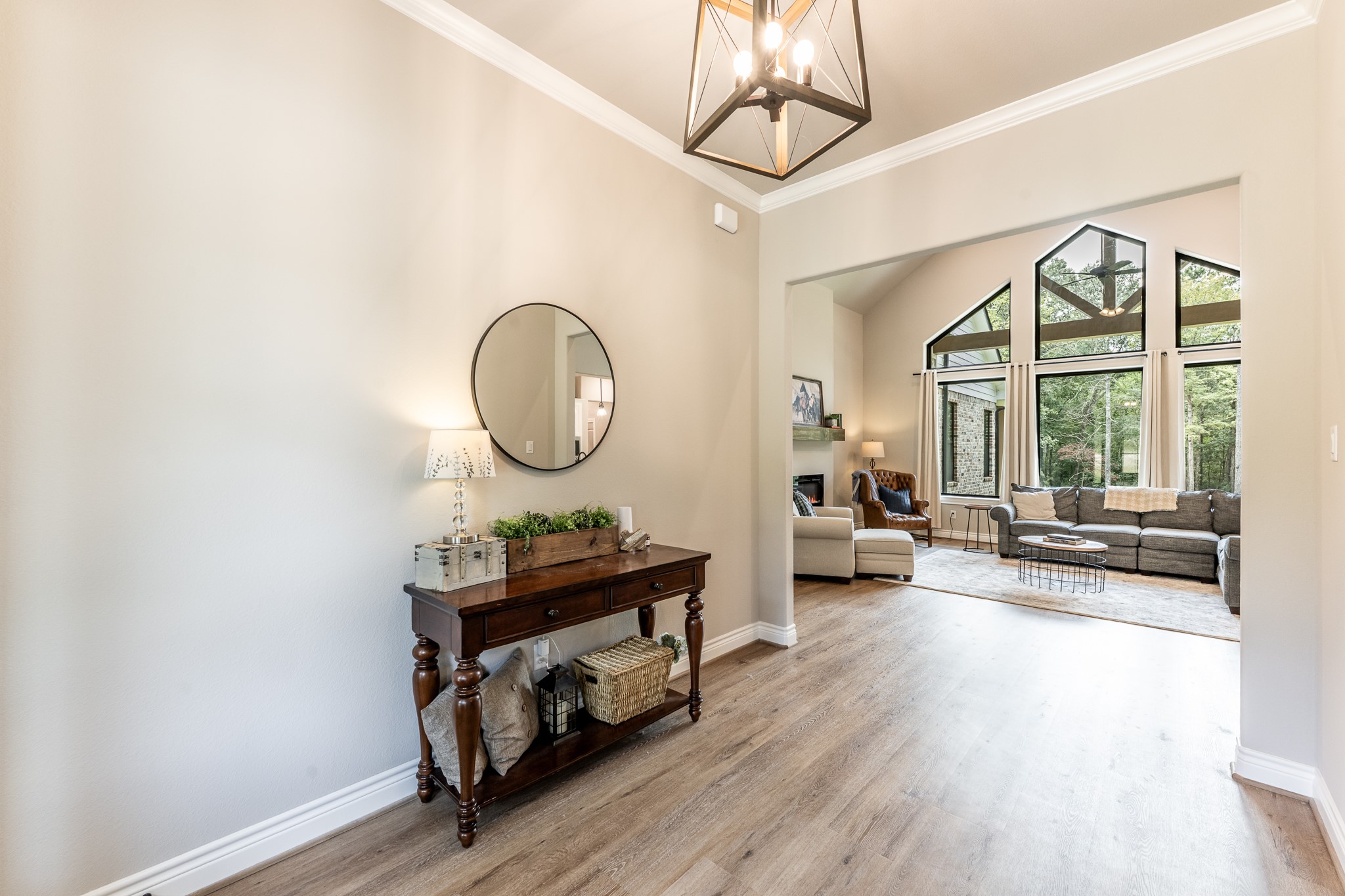 111 Eagle Run Road Willis, TX 77378 - Photo 7 of 44 Step inside to discover stunning vaulted windows and elegant vinyl plank flooring.