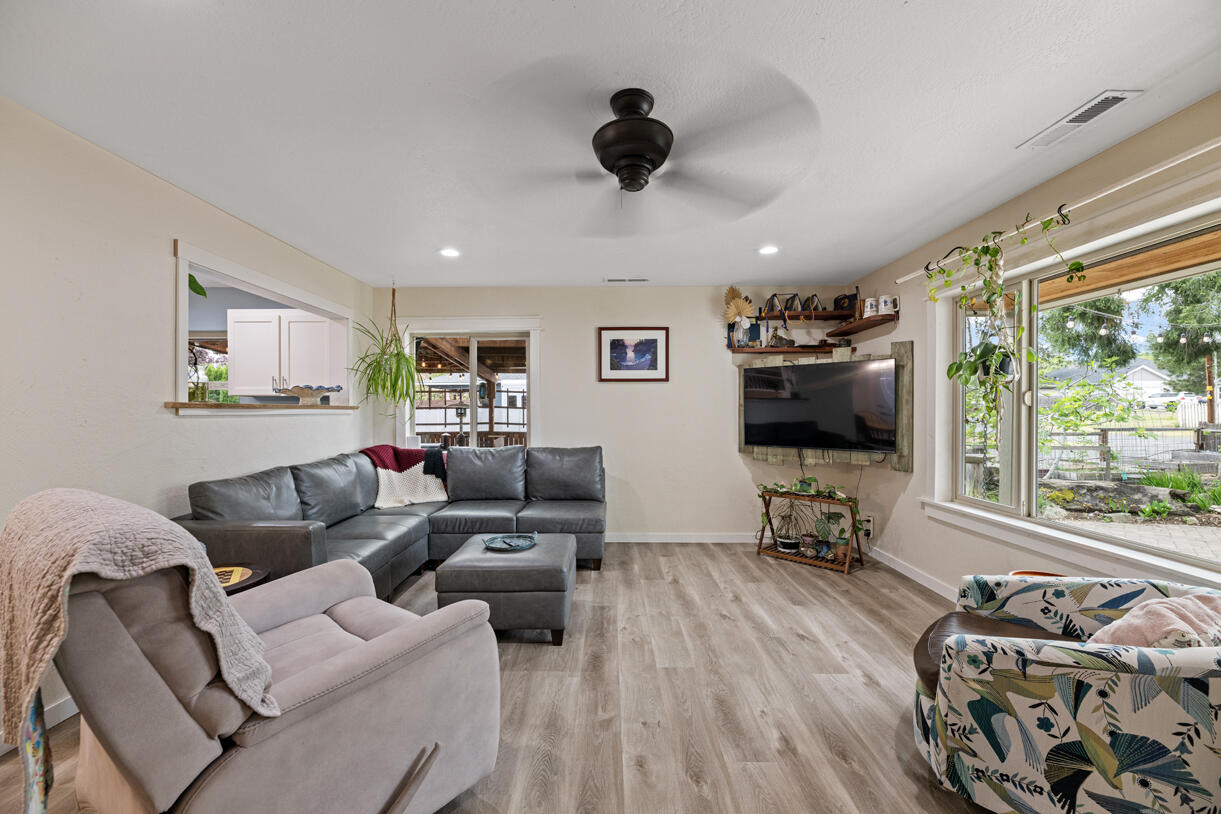 3747 Hilsinger Road Phoenix, OR 97535 - Photo 18 of 34 a living room with furniture a flat screen tv and a large window
