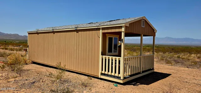 a view of a backyard with a fence
