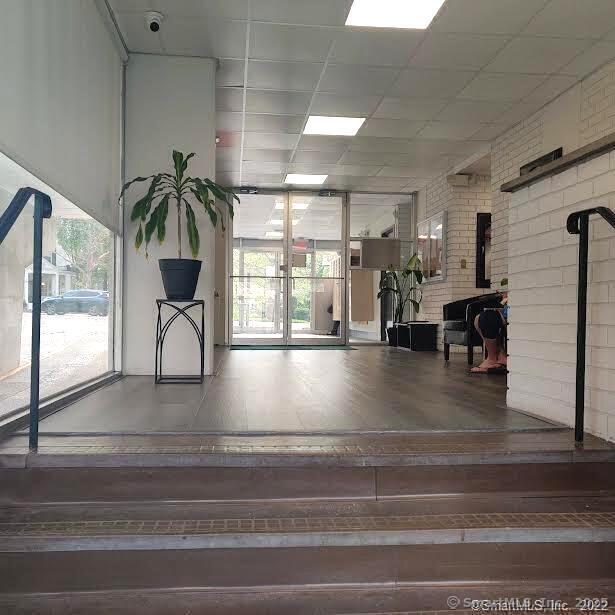 87 Glenbrook Road, Unit 3E Stamford, CT 06902 - Photo 4 of 11 a view hallway with couches and a potted plant on a bookshelf