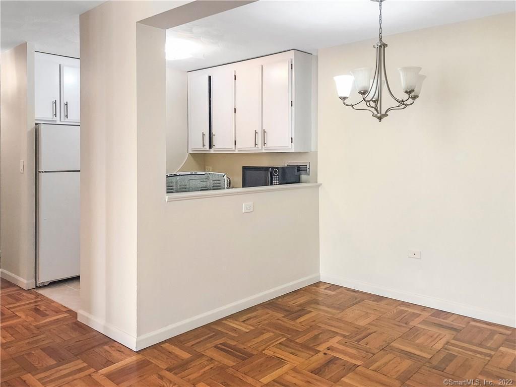 87 Glenbrook Road, Unit 3E Stamford, CT 06902 - Photo 6 of 11 a view of a livingroom with a chandelier