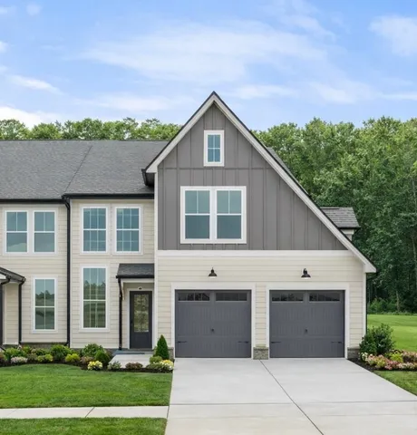 a view of a house with a yard and garage