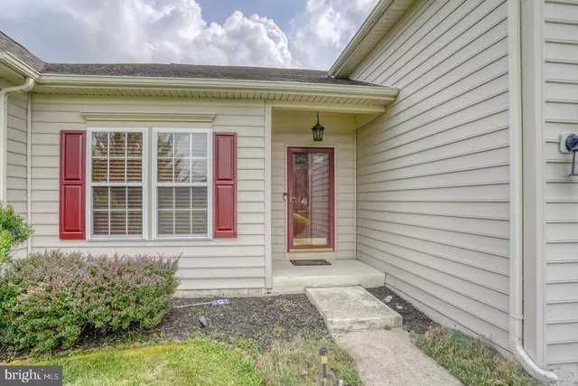 a view of hall way with furniture and stairs