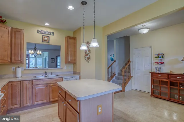 a kitchen with a sink appliances and cabinets