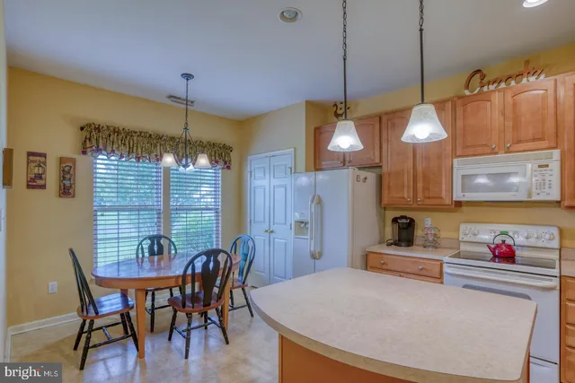 a view of a dining room with furniture and window