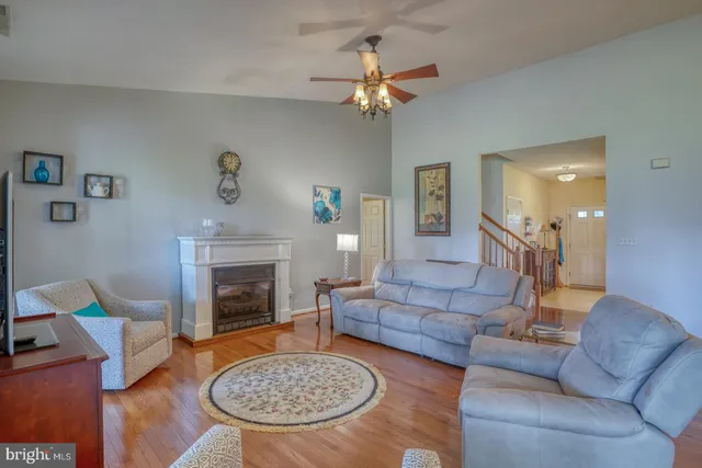 a view of a dining room with furniture a chandelier and wooden floor