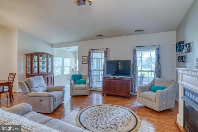 a living room with furniture a chandelier and a window