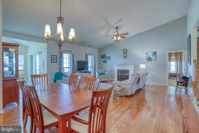 a view of a dining room with furniture wooden floor and a chandelier