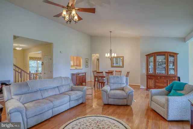 a view of a room with large windows and furniture
