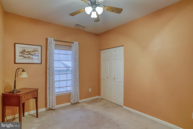 a view of a dining room with furniture large windows and wooden floor