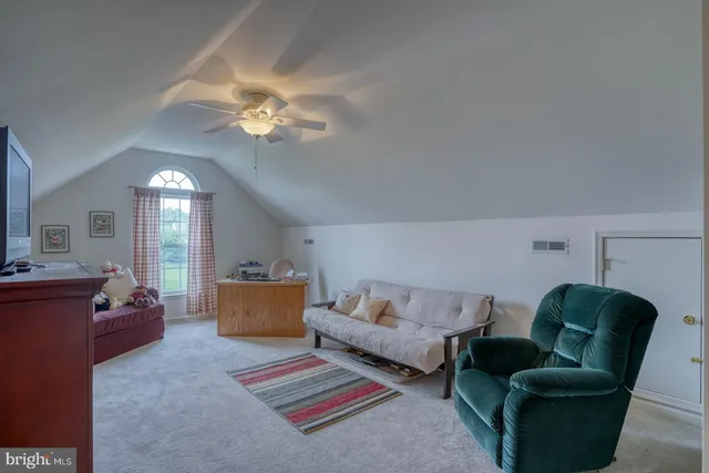 a view of a dining room with furniture wooden floor and a potted plant