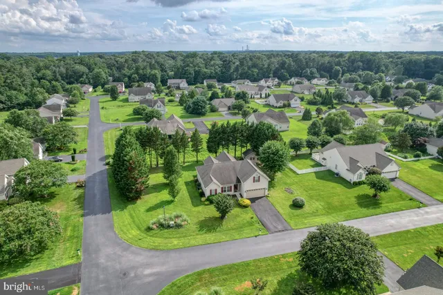 an aerial view of a house with yard and green space