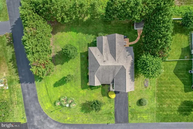 an aerial view of a house with a yard