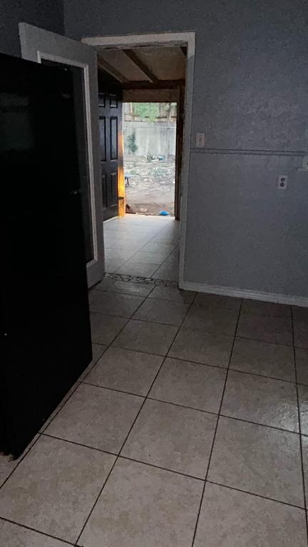 508 Bremser Avenue, Unit 506 Killeen, TX 76541 - Photo 6 of 9 Corridor with light tile patterned floors and baseboards