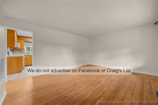 a view of an empty room and wooden floor