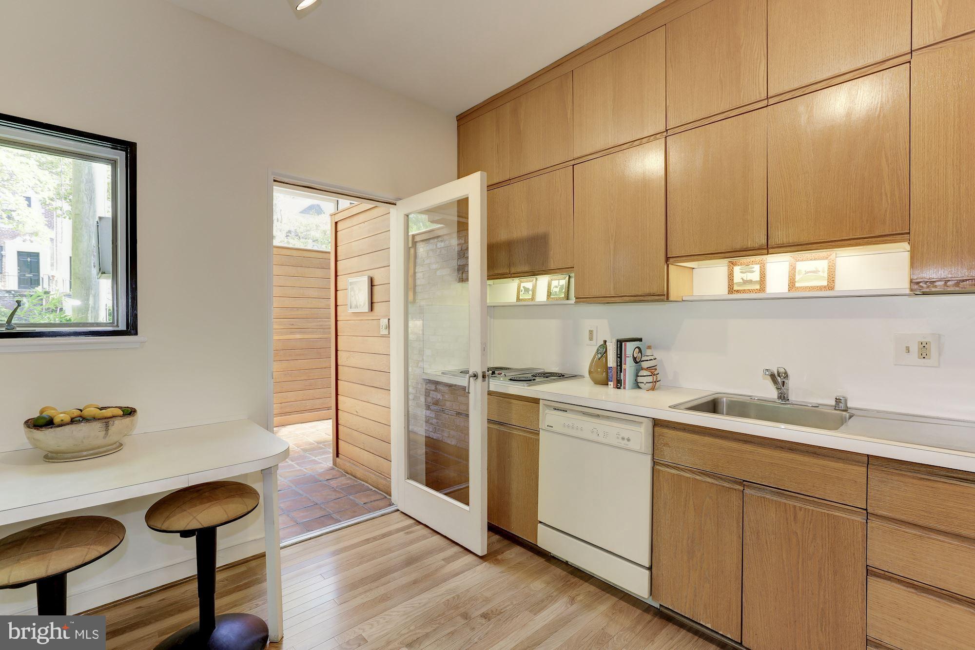 4870 Reservoir Road Northwest Washington, DC 20007 - Photo 18 of 44 Kitchen with New Hardwoods and Access to Sunroom