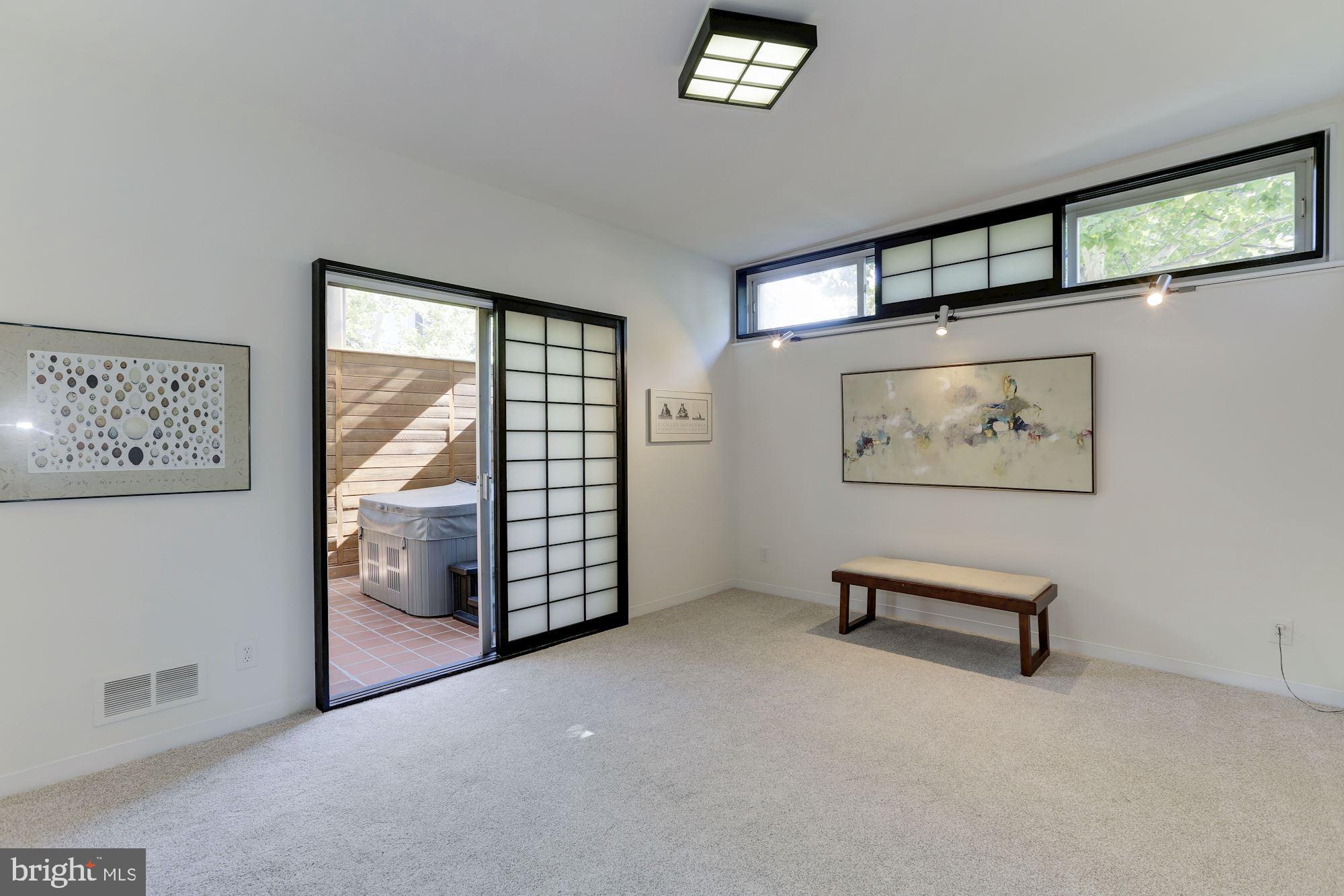 4870 Reservoir Road Northwest Washington, DC 20007 - Photo 22 of 44 Main Floor Master Bedroom with Doors to Sunroom