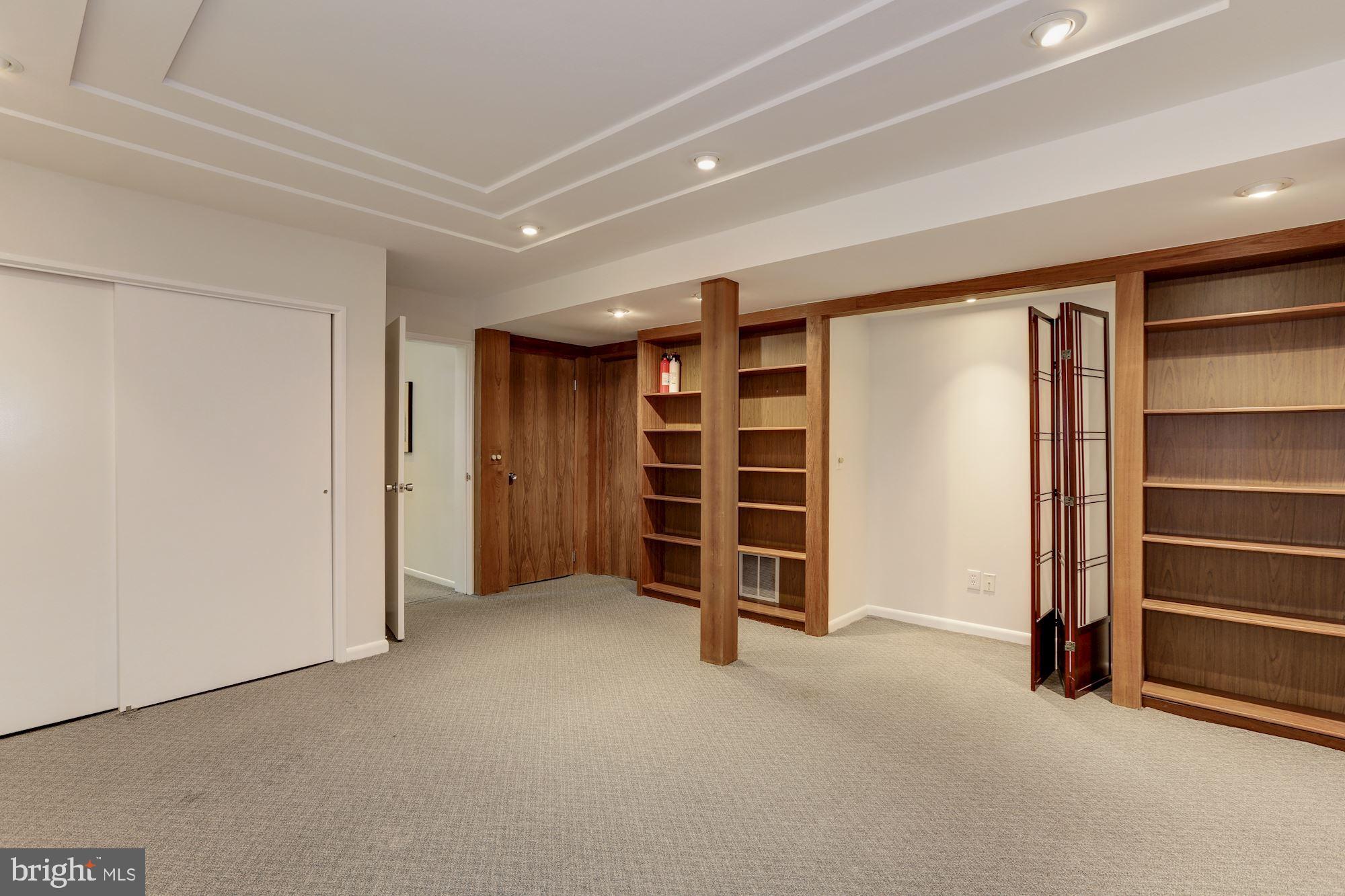 4870 Reservoir Road Northwest Washington, DC 20007 - Photo 38 of 44 Lower Level Bedroom with Two Closets and Bookcases
