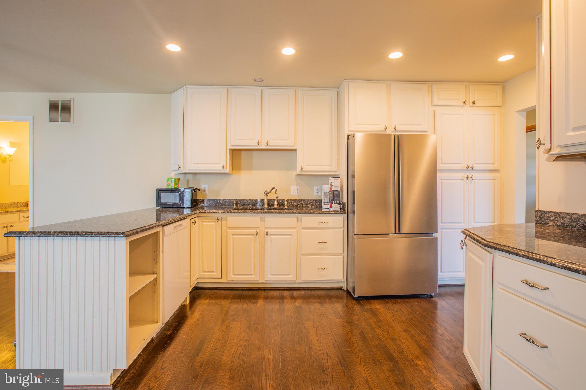 5806 Olson Road Brooklyn, MD 21225 - Photo 12 of 33 a kitchen with stainless steel appliances a refrigerator sink and microwave