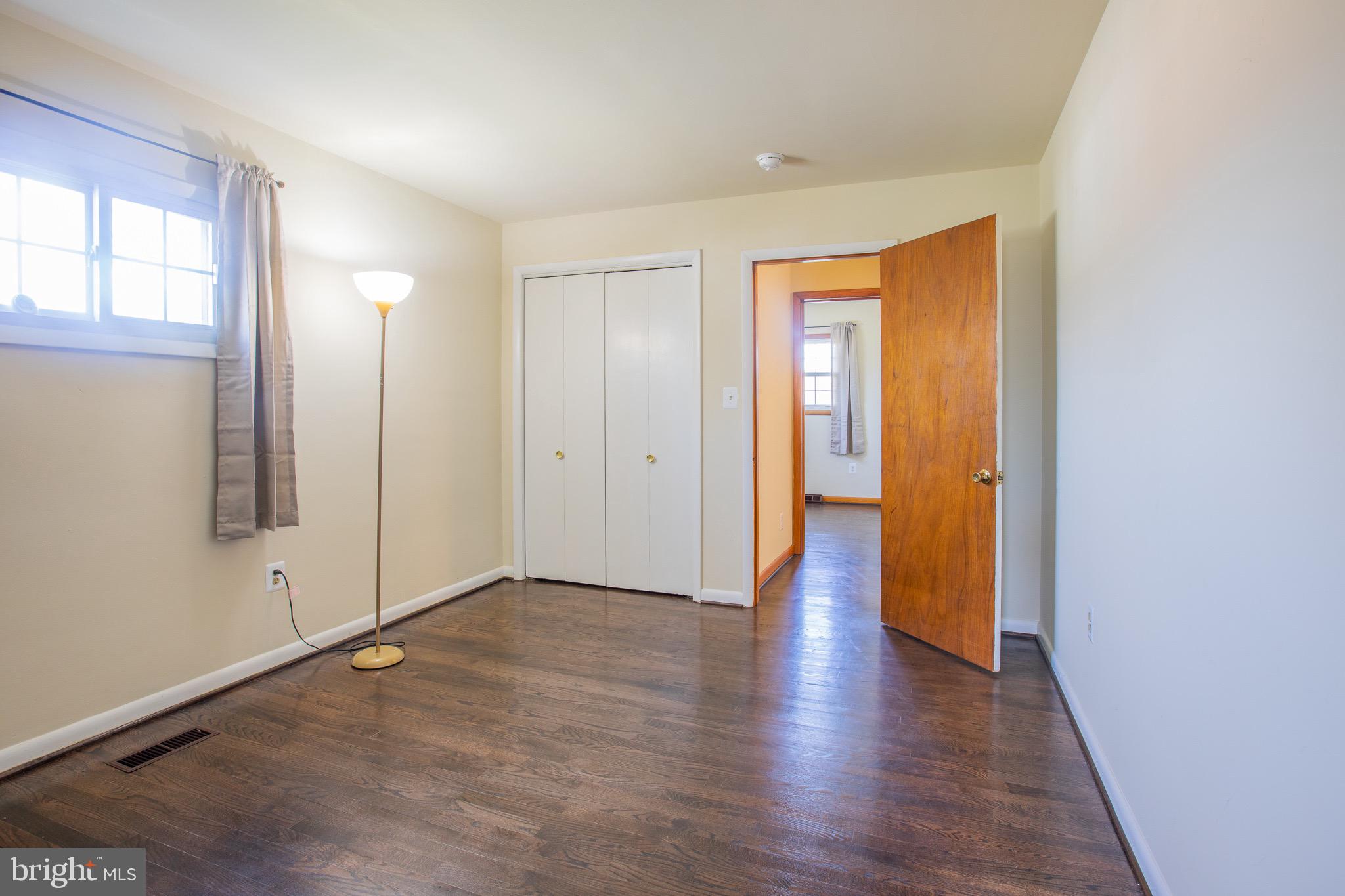 5806 Olson Road Brooklyn, MD 21225 - Photo 16 of 33 an empty room with wooden floor and windows
