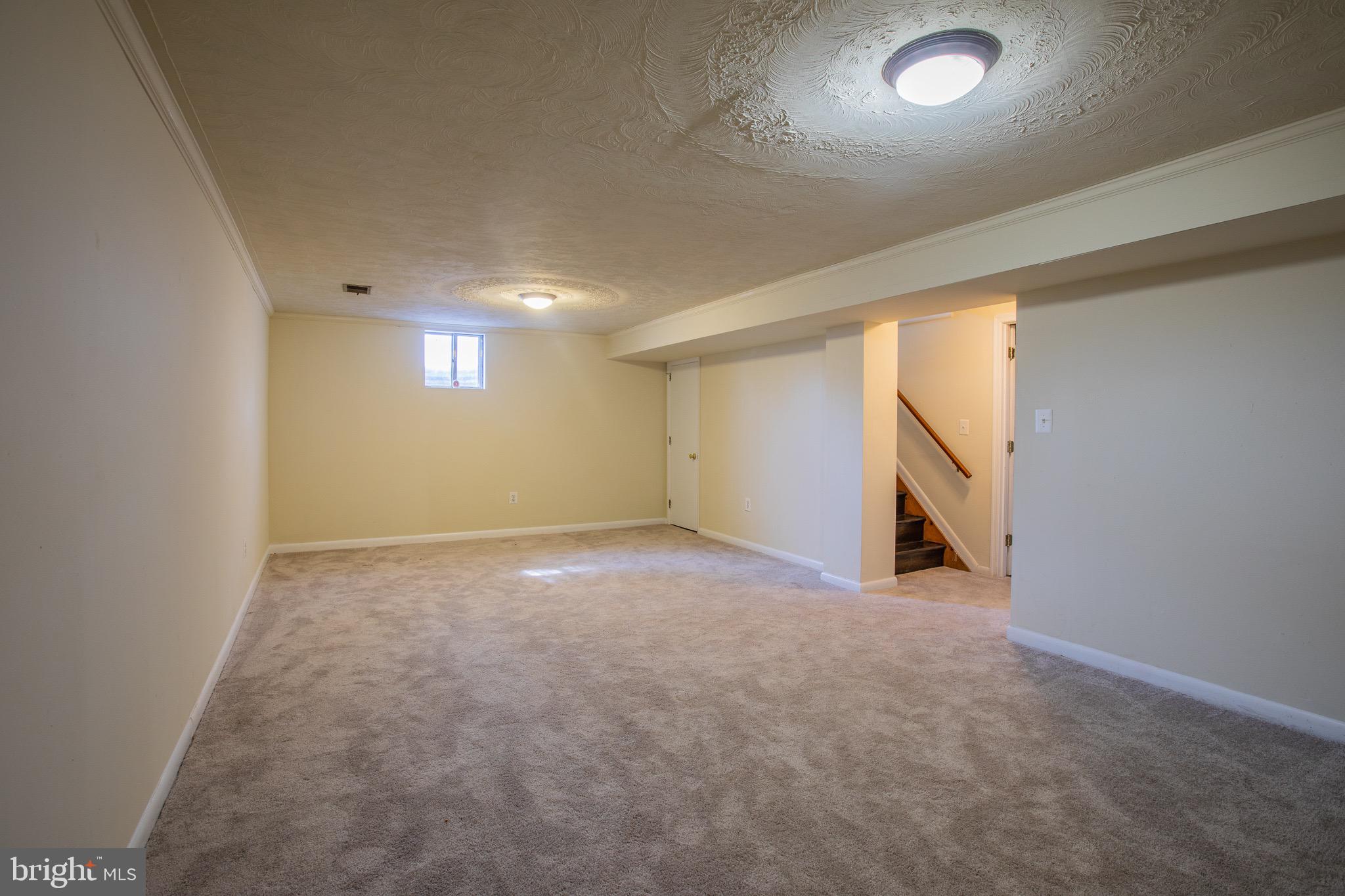 5806 Olson Road Brooklyn, MD 21225 - Photo 26 of 33 an empty room with a empty space and windows