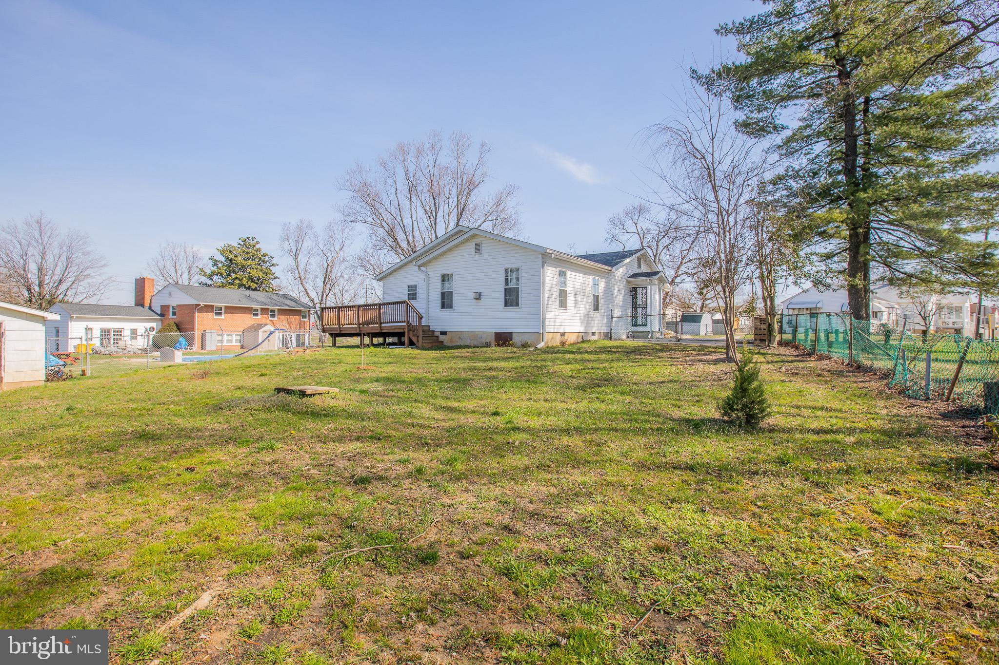 5806 Olson Road Brooklyn, MD 21225 - Photo 32 of 33 a white house with a big yard and large trees