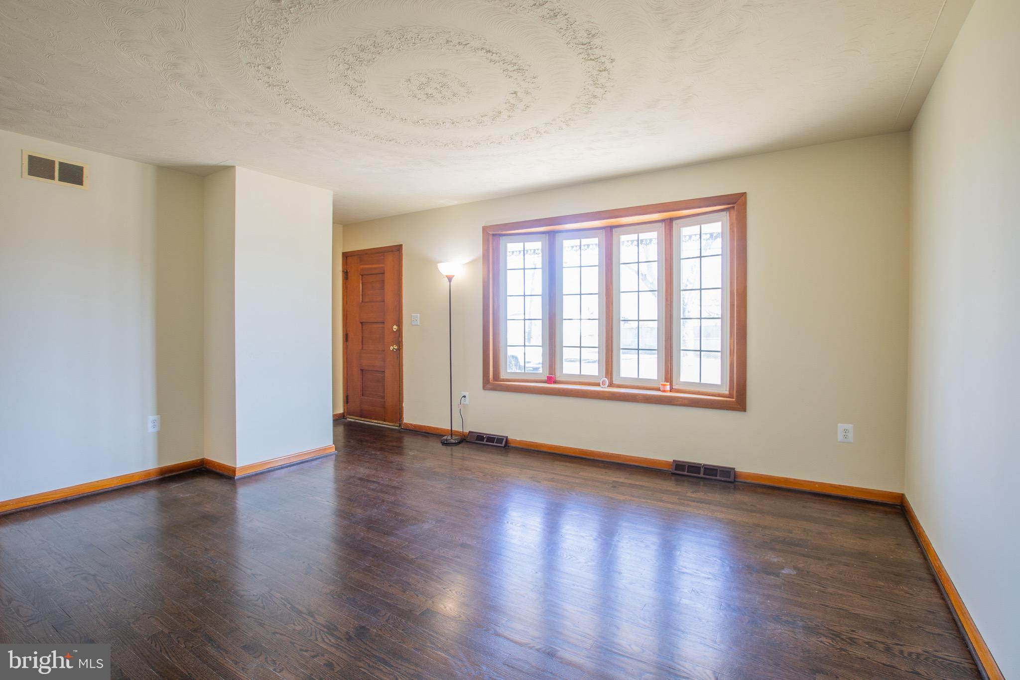 5806 Olson Road Brooklyn, MD 21225 - Photo 6 of 33 wooden floor in an empty room with a window