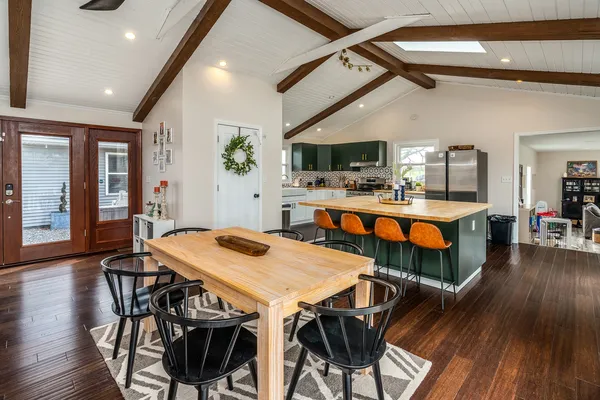 a kitchen with stainless steel appliances granite countertop a stove a sink and a refrigerator