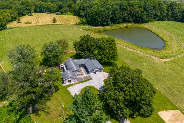 an aerial view of a house with garden space and street view