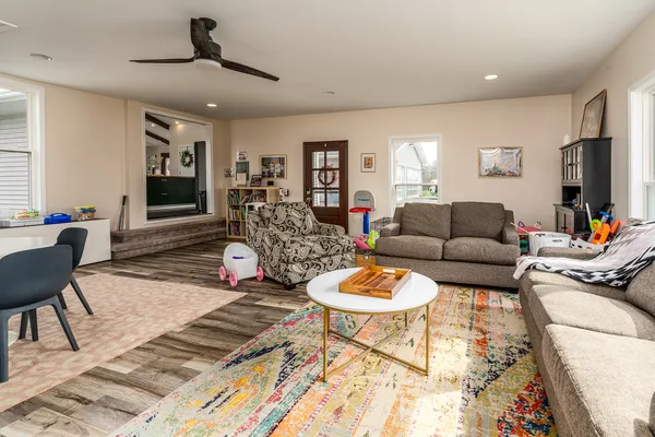 a spacious bedroom with a bed and a flat screen tv