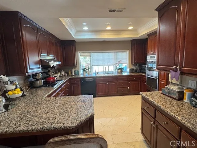a kitchen with sink refrigerator and window