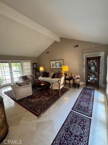 a living room with furniture rug and window